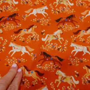 Cotton Fabric Dashwood Craft Cotton Merry Go Round Horses Terracotta Rust